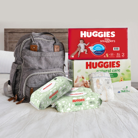 Pack of Huggies® Little Snugglers® and Huggies® Natural Care® Sensitive Wipes in a diaper bag