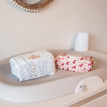Pack of Huggies® Nourish™ Baby Wipes and  Huggies® Little Snugglers® Diapers on the table