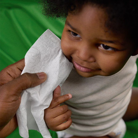 Image of baby’s face being wiped with Huggies® Extra Large Baby Wipes. They are soft and thick to help maximize comfort